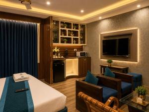 a hotel room with a bed and a living room at Castal Blue Hotel Near IGI Delhi Airport - Free Breakfast and Dinner complementry in New Delhi