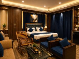 a bedroom with a bed and a living room at Castal Blue Hotel Near IGI Delhi Airport - Free Breakfast and Dinner complementry in New Delhi