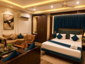 a hotel room with a bed and a couch at Castal Blue Hotel Near IGI Delhi Airport - Free Breakfast and Dinner complementry in New Delhi +18 photos