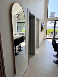 a mirror in a room with a dining room at Järvemetsa Stay in Dejevo