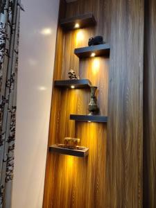 a wooden wall with shelves on it at Residency Trilok in Varanasi