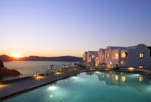 a large swimming pool with a view of the water at The Duchess in Therasia