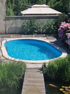 a large swimming pool in a yard with a wooden deck at Ferienwohnung Auenweg in Radebeul