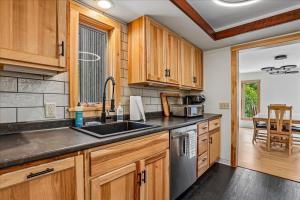 a kitchen with wooden cabinets and a sink at The Mercer House in Stowe