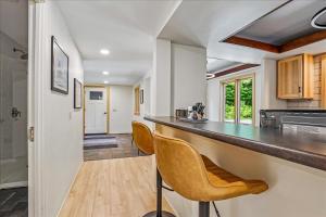 a kitchen with a counter and chairs in a room at The Mercer House in Stowe +32 photos