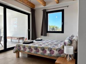 a bedroom with a bed and a window at BnB Paradiso in Carloforte