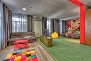 a living room with a couch and a table at Emigrand Art Hotel in Uzhhorod