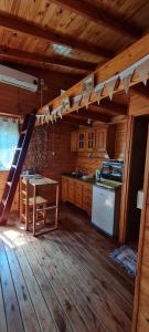 a kitchen with a table and a ladder in a cabin at Cabaña Las Casuarinas del Delta de Tigre in Dique Luján