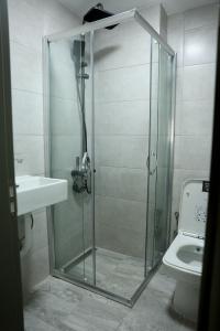 a glass shower in a bathroom with a toilet at Ceylan Apart Otel in Tekirdağ