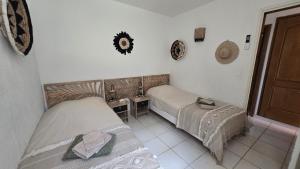 a bedroom with two beds and a table and a door at Favone Mini Villa Playa del Oro in Favone +54 photos
