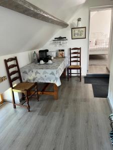a dining room with a table and two chairs at Chez Karen in Montlay-en-Auxois