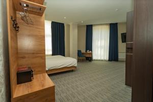 a hotel room with a bed and a desk at Hanzade Palace in Samarkand +53 photos