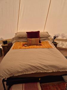 a bed in a room with a large bed with at Lyng Farm Campsite in Brisley
