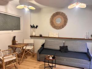 a living room with a couch and a table at les thermes du beffroi in Calais