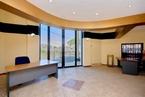 an office with a desk and a large window at Airport Lodge Hotel in Kempton Park