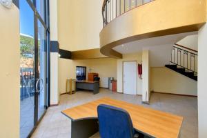 a dining room with a table and chairs and a staircase at Airport Lodge Hotel in Kempton Park
