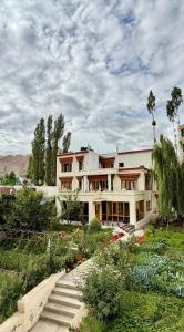 a large building with a garden in front of it at Niri-la Ladakh Leh in Leh