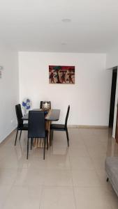 a dining room with a table and black chairs at Sossego & Conforto in Espargos