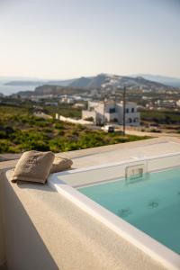a towel sitting on the edge of a swimming pool at Avento Luxury Suites in Santorini