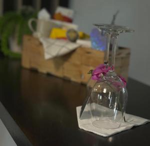 a glass vase with a flower in it on a table at Lk Apartments in Halmstad