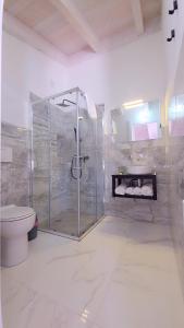 a bathroom with a shower and a toilet at Tenuta Feraxi - Private Paradise in Costa Rei +72 photos