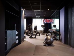 a gym with several chairs and a ball on the floor at TRIBE Milano Malpensa in Vizzola Ticino