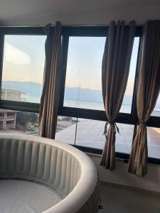 a bedroom with a bed and a large window at Mila Todorovska in Star Dojran
