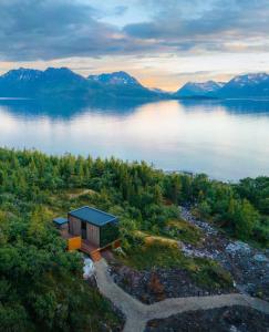 an aerial view of a cabin on the shore of a lake at WonderInn Arctic in Utstrand