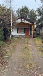 a house with a dirt road in front of it at Cielo Azul 2 in Villa Pehuenia