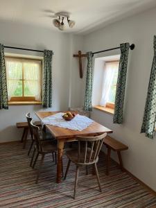 a dining room with a wooden table and chairs at Auf der Woad in Tittmoning