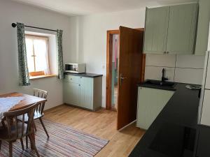 a kitchen and dining room with a table and a table and chairs at Auf der Woad in Tittmoning