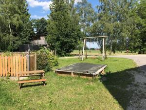 a picnic table and a bench in a yard at Auf der Woad in Tittmoning +3 photos