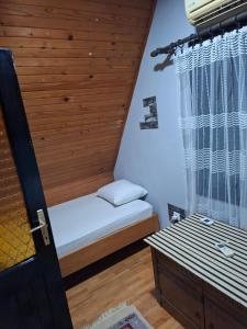 a small bedroom with a bed and a window at Vikendica DUNAV in Golubac +48 photos