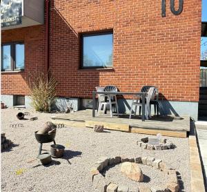 a patio with a table and chairs in front of a brick building at Lk Apartments in Halmstad