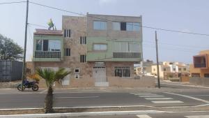 a building with a motorcycle parked in front of it at Sossego & Conforto in Espargos