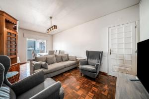 a living room with a couch and two chairs at HolidaysPT - Luanda - 2 Bedroom Apartment in Olhão +22 photos
