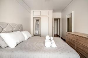 a bedroom with a large bed with white pillows on it at HolidaysPT - Luanda - 2 Bedroom Apartment in Olhão