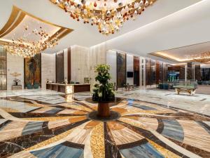 a lobby of a building with a chandelier at Rixos Premium Alamein in El Alamein