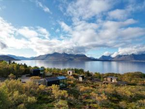 a view of a lake with mountains in the background at WonderInn Arctic in Utstrand