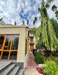 a house with a tree on the side of it at Niri-la Ladakh Leh in Leh +10 photos