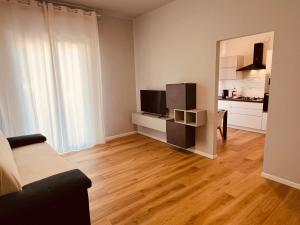 a living room with a couch and a television at Appartamenti Colombo in Arma di Taggia