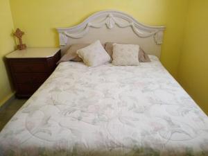 a bedroom with a large bed with pink flowers on it at Spacious Beachfront Escape at Playa Guayanes for Large Groups in Yabucoa