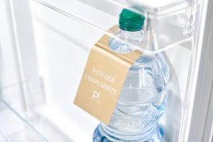 a bottle of water in a refrigerator with a tag on it at Residenza Ximenes in Palermo
