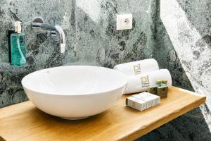 a bathroom with a white bowl sink and towels at Residenza Ximenes in Palermo