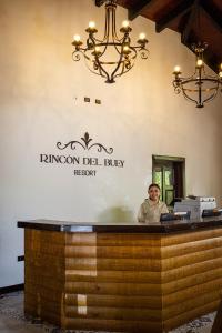 a man sitting at a bar in a restaurant at Rincon del Buey Resort in Copán Ruinas