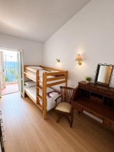 a room with two bunk beds and a piano at Vila Petra in Perazića Do