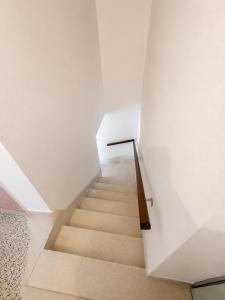 a staircase in a room with white walls and a stair case at Vila Petra in Perazića Do