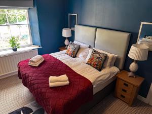 a bedroom with a large bed with two towels on it at The Red Lion Hotel in Oakford