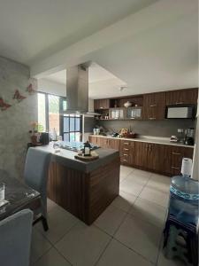 a large kitchen with a island in the middle at Alojamiento el Toro in Gómez