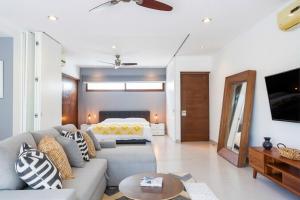 a living room with a couch and a bed at Bright 1 BD with private Terrace near TULUM in Akumal